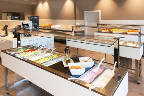 a buffet line with many different types of food at a&o Hamburg City in Hamburg