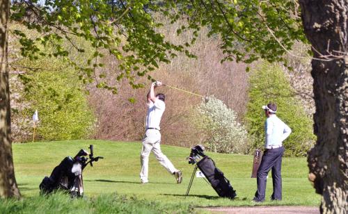 a man playing a game of golf with a dog at Green Hotel in Kinross