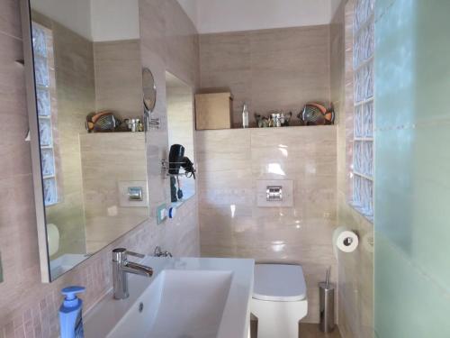 a bathroom with a sink and a toilet at Casa Beghino in Lama Mocogno