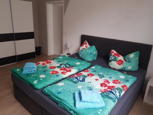a couch with two blankets and pillows on it at Bed and Breakfast Zeulenroda in Zeulenroda