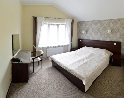 Postel nebo postele na pokoji v ubytování Hotel Complex Dvir Kniazhoiy Korony