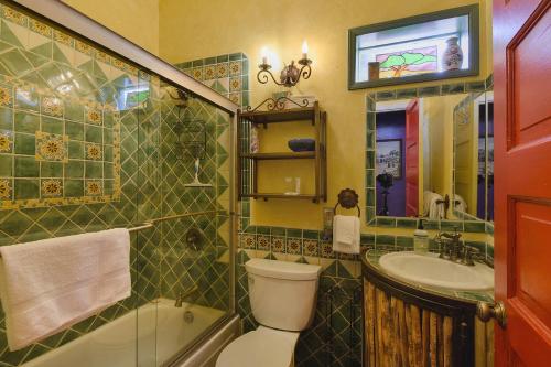 a bathroom with a toilet and a sink and a tub at Barrio Casita 1 in Tucson
