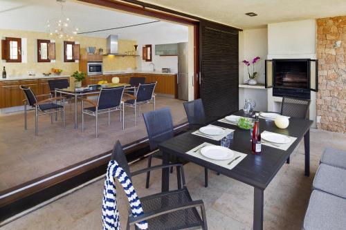 een eetkamer en een keuken met een tafel en stoelen bij CAN NOVES - Villa de 2 suites (3) in Sant Francesc Xavier