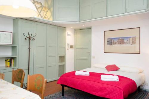 a bedroom with a large bed with a red blanket at Coliseum top floor with terrace and view in Rome