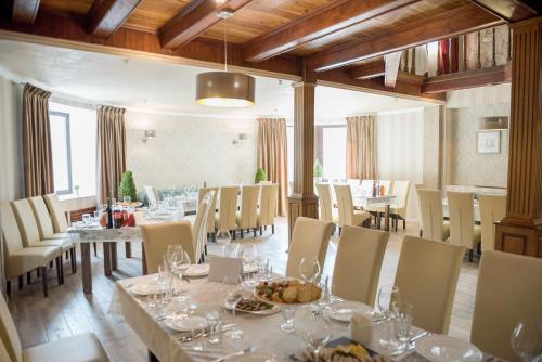 a large dining room with tables and chairs at Geneva Hotel in Ternopil