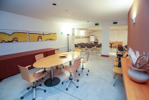 a room with a table and chairs in a classroom at Hotel Aleramo in Asti