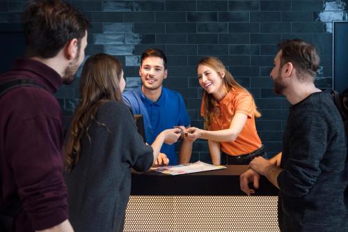 a group of people standing around a table at a&o Hamburg City in Hamburg