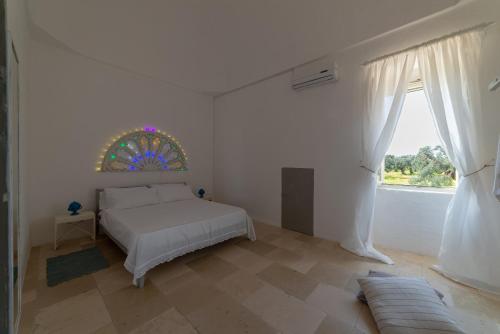 A bed or beds in a room at Masseria Pugliese Farm