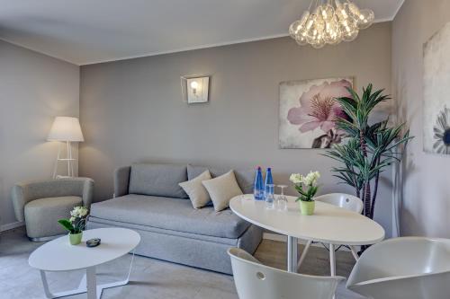a living room with a couch and two tables at Parc Hotel Germano Suites & Apartments in Bardolino