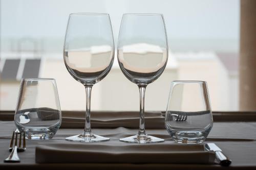 three glasses of wine sitting on a table at Thermae Palace in Ostend