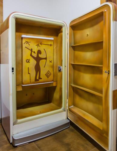an open refrigerator with a sign on the door at Flor de Limão Hotel Boutique in Coroa Vermelha