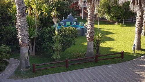 a park with palm trees and a wooden fence at The Gull in Sedgefield
