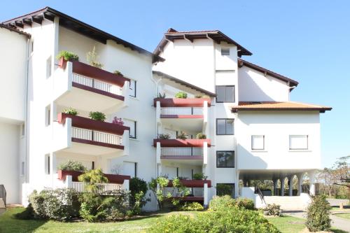 an apartment building with balconies and plants at VVF Résidence Anglet in Anglet