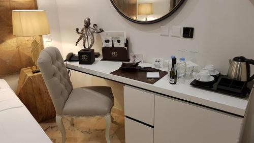 a room with a desk with a chair and a mirror at 50th Guest House in Vittoriosa