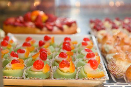a bunch of fruit desserts in trays on a table at Casa Sarina in Marsala
