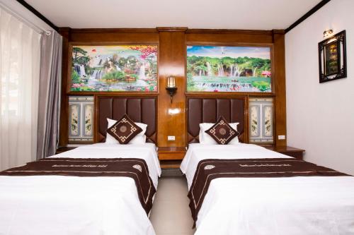 a hotel room with two beds and two windows at Vientiane Garden Villa Hotel in Vientiane