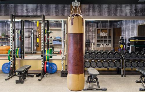 a gym with a large punching bag and weights at South Lodge in Lower Beeding