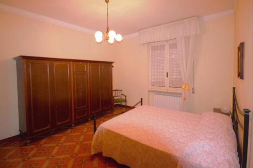 a bedroom with a bed and a cabinet and a window at Casa vacanza Francesca in Levanto