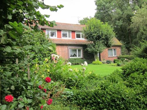 a brick house with a garden in front of it at Haus Annegret in Wietzendorf