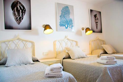een slaapkamer met twee bedden met handdoeken erop bij Villa La Concha in Playa Honda