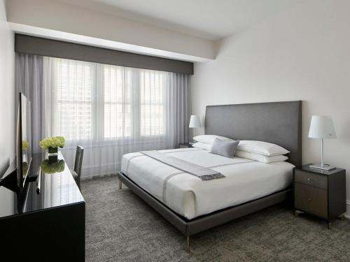 a bedroom with a large bed and a television at AKA Rittenhouse Square in Philadelphia