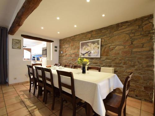 a dining room with a table and chairs at Former farmhouse in a quiet village in Manhay