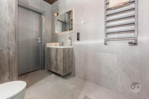 a bathroom with a toilet and a sink and a shower at Apartament Natura I in Władysławowo