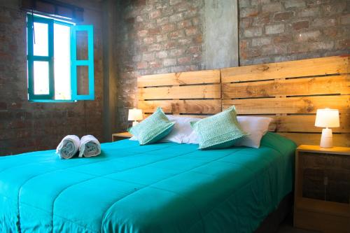 Ένα ή περισσότερα κρεβάτια σε δωμάτιο στο The Upcycled Hostel Huacachina