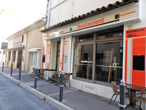 a row of tables and chairs outside of a restaurant at Lou pescadou in Saint-Raphaël