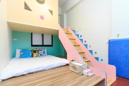 a childrens room with a bunk bed and a staircase at Yilan Dongshan Cypress B&B in Dongshan