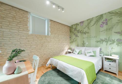 ein Schlafzimmer mit einem Bett und einer Ziegelwand in der Unterkunft Apartments Villa Mak in Split