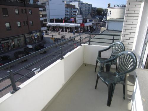 a couple of chairs sitting on top of a balcony at Hotel Dünenburg in Westerland (Sylt)