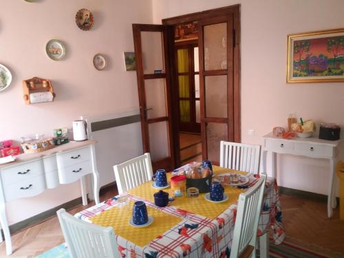 a dining room with a yellow table and chairs at Da Selly in Mantova