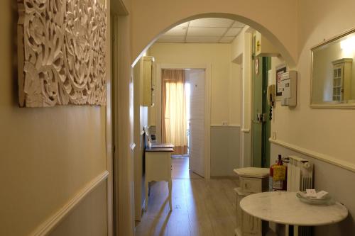 a hallway with an archway and a table in a room at Residenza Le Rondini in Florence