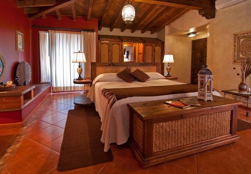 a bedroom with a large bed and a table at Porton del Cielo in Pátzcuaro