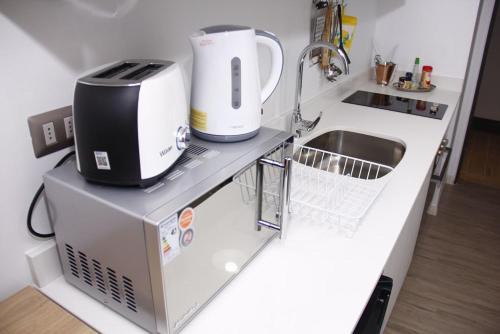 a kitchen with a sink and a appliance on a counter at Departamentos de Lujo ,costado Mall Plaza in Antofagasta