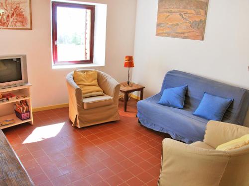 a living room with a couch and a tv at Holiday Home Les Geais-1 by Interhome in Saint-Saturnin-lès-Apt