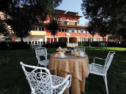 a table in a yard with chairs and a table with food on it at Stella Alpina Hotel e Ristorante in Druogno