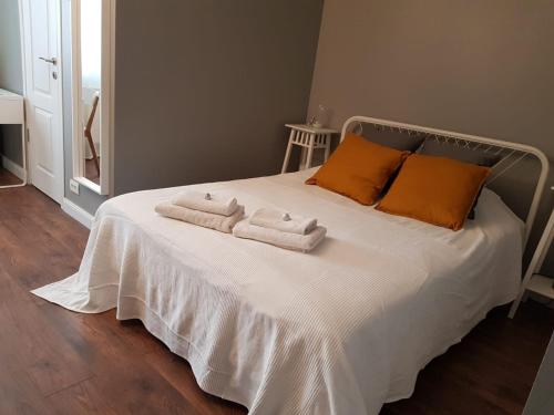 a bedroom with a bed with two towels on it at D&C Studio in Bucharest