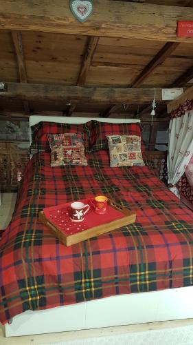a plaid bed with a tray on top of it at Loft Giuly in Vignanello