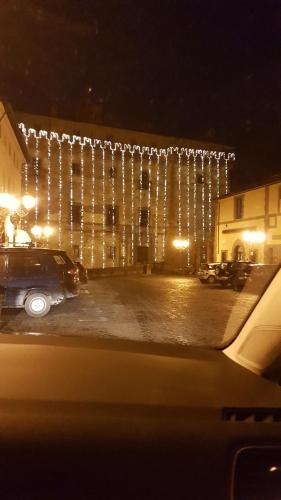 a building with christmas lights on it at night at Loft Giuly in Vignanello