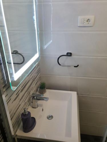 a white sink in a bathroom with a window at Ana Tudor Apartments in Hvar