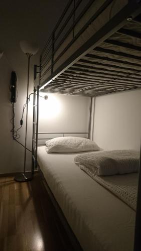 a bedroom with two bunk beds and a lamp at ABAI Apartments 1150 only WWW-On-line-Check-in & SelfService in Vienna