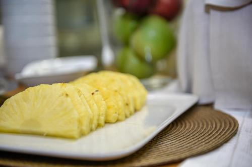 a piece of fruit on a plate on a table at Baldinini Hotel in Rimini