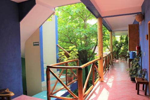 a staircase in a house with a view of trees at Casa Almendro in Tulum