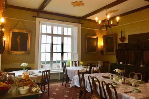 a dining room filled with tables and chairs at The Castle in Castlehaven