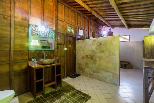 a bathroom with a toilet and a sink at Villa Melasti Amed in Amed