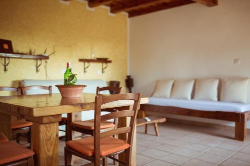 a dining room with a table and a bed at Casa Rustick in Sant Francesc Xavier