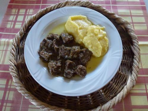 a white plate with food on a table at Alloggio Conca Dei Parpari in Rovere Veronese