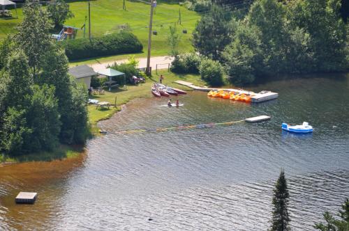 an aerial view of a river with boats on it at Le Boisé du Lac in Mont-Tremblant
